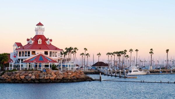 Long Beach shoreline with marina and anchored boats.