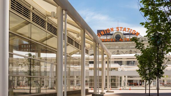 Union Station in Denver with stone construction and neon signs.