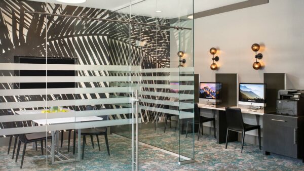 Apartment community business center with conference room/MAC work stations at Griffis Fitzsimons South in Aurora, Colorado .