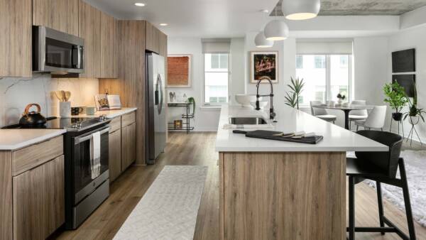 Apartment Kitchen with Stainless Steel Appliances, Dining Room and with wood floors.