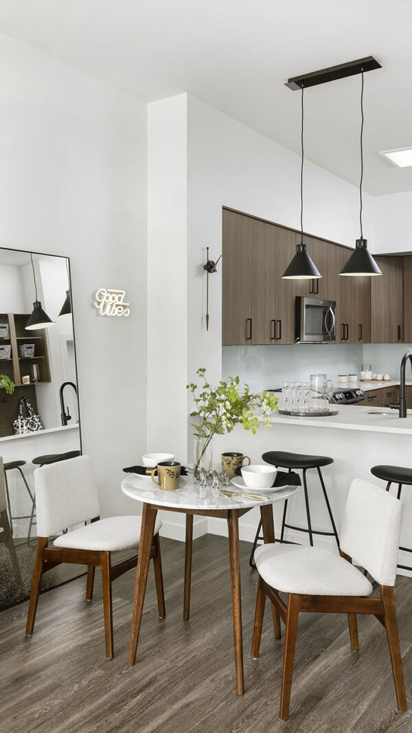 Apartment Kitchen with Stainless Steel Appliances, quartz countertop and hardwood flooring.