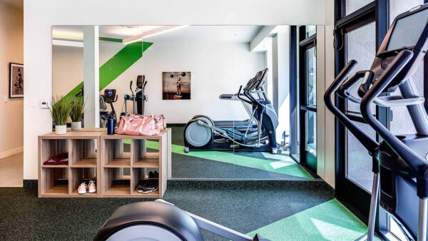 Apartment community 24-hour fitness center with Fitness on Demand™ at Griffis Pine Avenue in Long Beach, California.