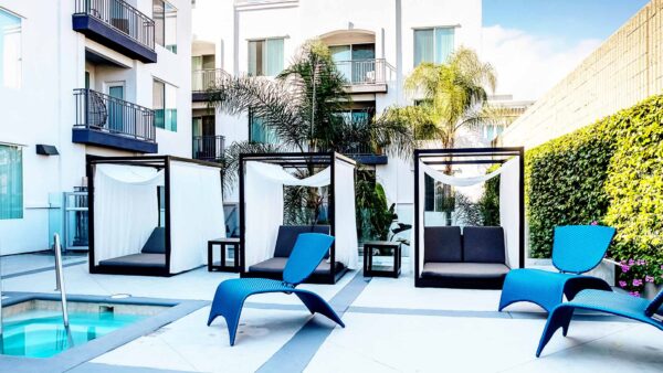 Apartment community resort style pool + cabanas at Griffis Pine Ave in Long Beach, California.
