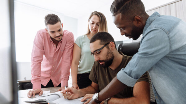 Employees collaborating together in office.
