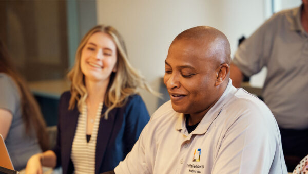 Griffis employees laughing together during meeting.