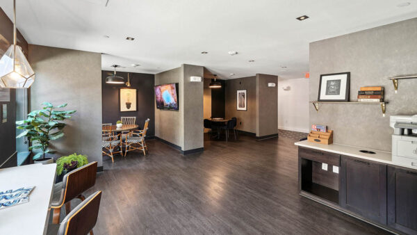 Wifi lounge with office printer, working stations, and wood style floor.