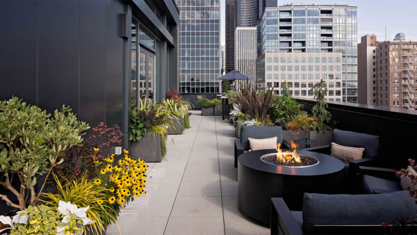 Apartment community rooftop deck and fire pit at Griffis Seattle Waterfront in Seattle, Washington.