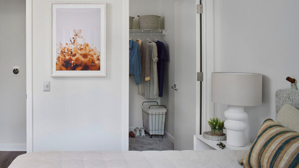 Spacious apartment bedroom with large closet and polished concrete flooring.