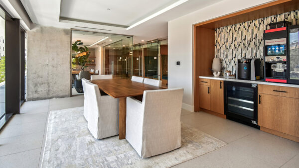 Griffis West Palm apartment coworking lounge with coffee machine and dining table.