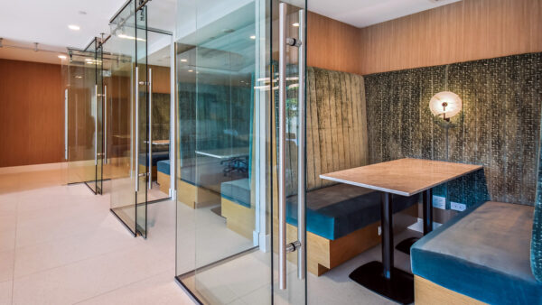 Griffis West Palm apartments coworking lounge with glass walled coworking pods.