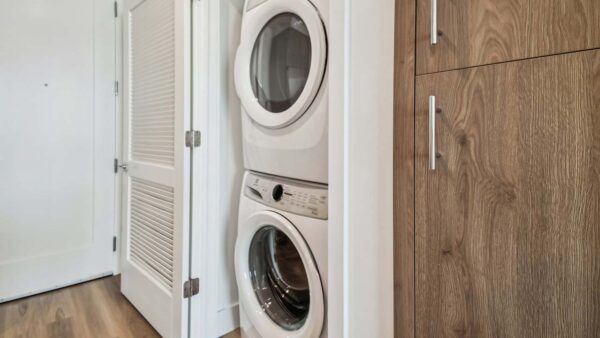 Griffis West Palm apartment laundry closet with stacked washer dryer.