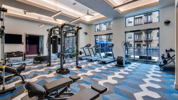 Griffis Frisco fitness center with cardio machines and weight equipment.