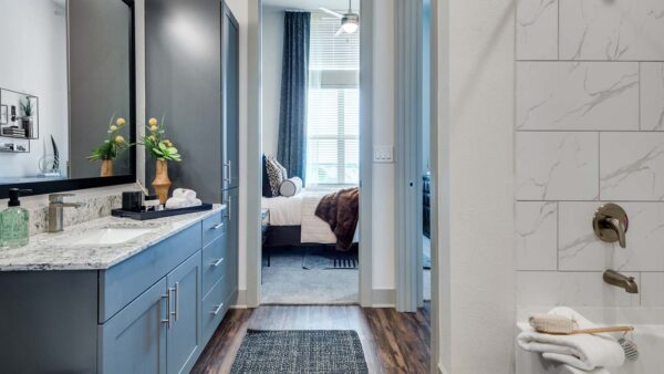 Griffis Frisco apartment bathroom with wood style floor.