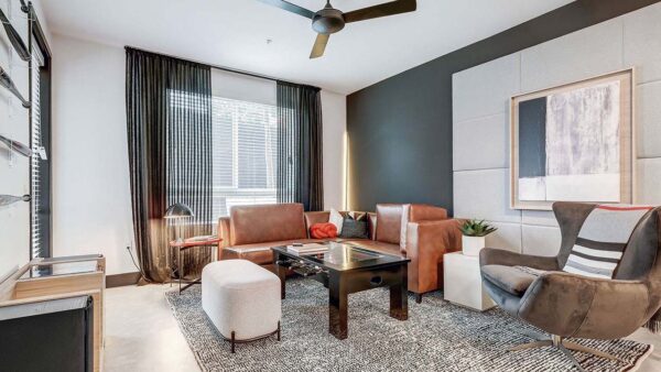 Griffis Platinum Triangle apartment living room with wood style flooring.