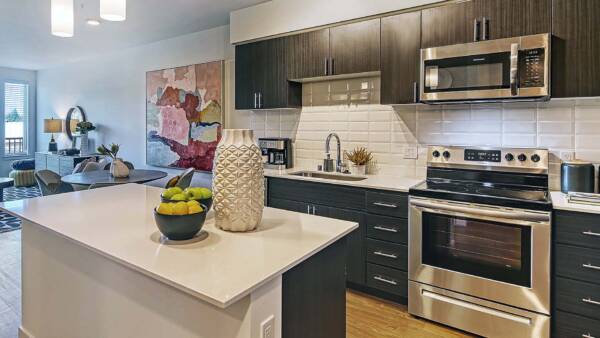 Griffis Shoreline apartment kitchen with stainless steel appliances and quartz countertops.