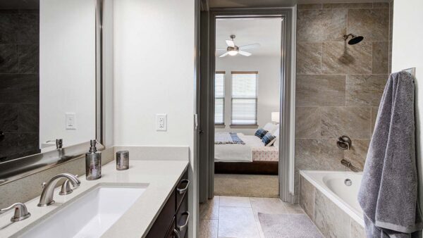 Griffis Uptown apartment bathroom with tiled shower tub.