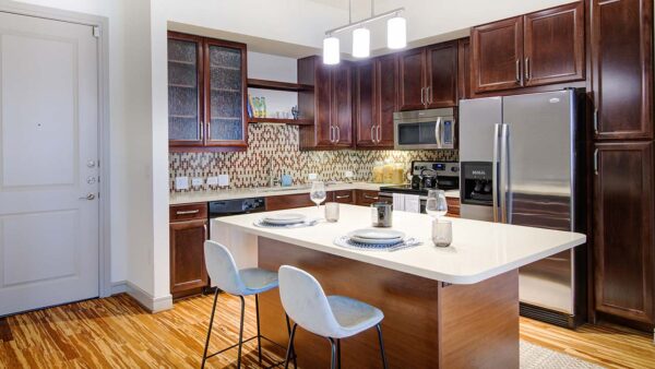 Griffis Uptown apartment kitchen with quartz countertops and stainless steel appliances.