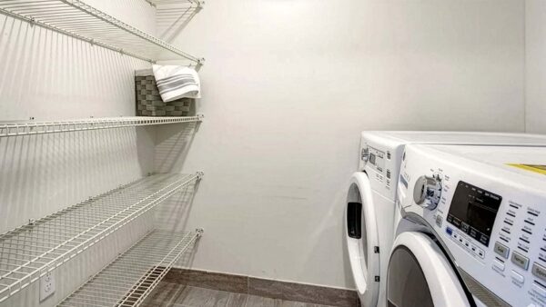 Griffis Pompano Beach apartment laundry room with washer and dryer.