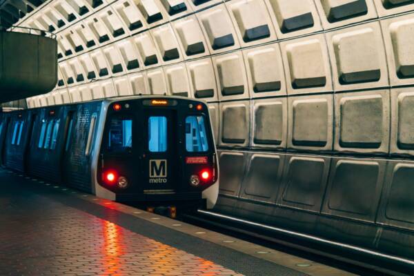 Washington Metro train arriving at an underground station platform.