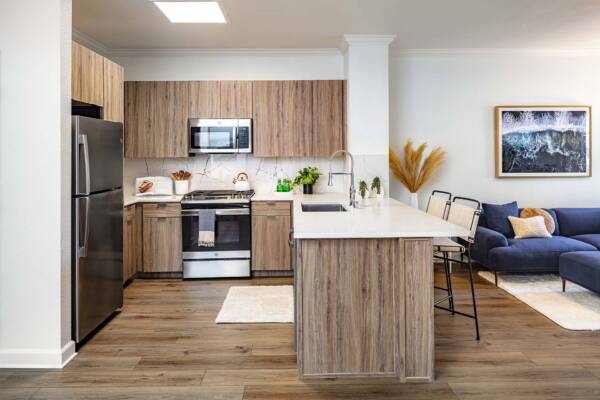 Griffis South Bay apartment kitchen with wood style floor and stainless steel appliances.